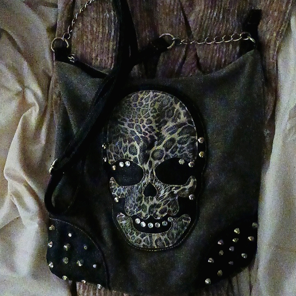 I'm selling this cute emo School purse and it is so cute but there's a tiny hole